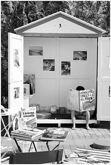 photo noir et blanc "Les Poux".Durant l'été, la ville de Granville propose des ateliers de lecture sur la promenade du Plat Gousset. Un jeune garçon semble absorbé par la lecture d'une bande déssinée de Pef.© 2010 Christophe Letellier tous droits réservés. Reproduction interdite. Pour revenir à la galerie, cliquer sur la photo
