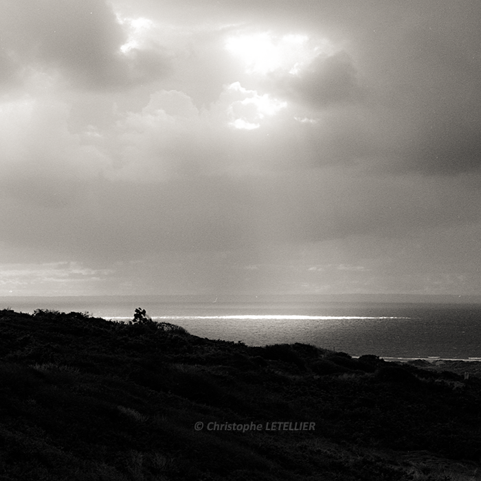 Photo noir et blanc dune spectaculaire trouée de lumière du soleil venant faire une tache lumineuse sur la mer pres d'Agon Coutainville © Christophe Letellier tous droits réservés. Pour revenir à la galerie, faites un clic-gauche sur la photo.